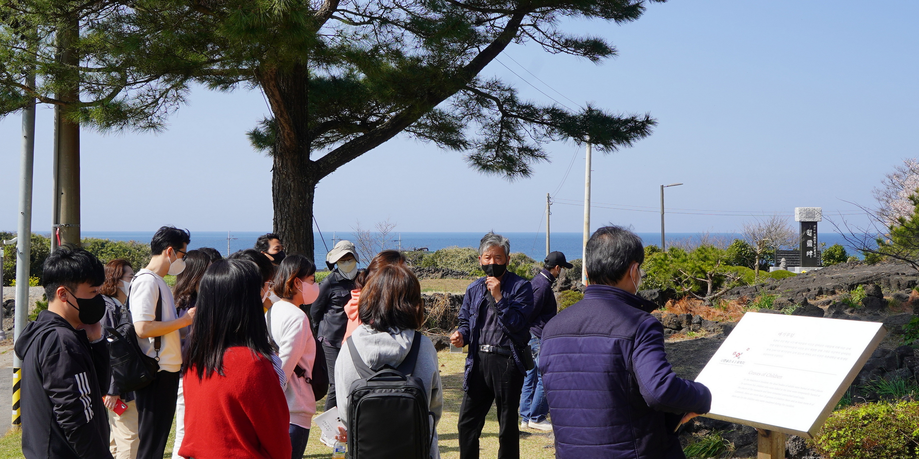 Staff of the foundation listening to an explanation of the “Graves of Children” outside the Neobeunsungi April 3rd Memorial Hall
