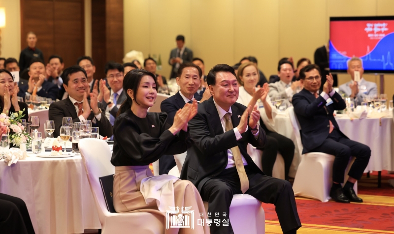 President Yoon Suk Yeol and first lady Kim on July 12 clap at a roundtable of Korean expatriates in Poland at a Warsaw hotel.